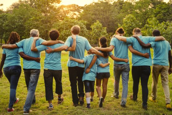 Volunteers holding around each other