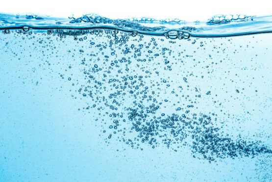 Many bubbles in water close up, abstract water wave with bubbles